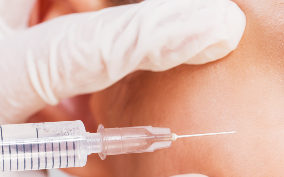 Practitioner injecting a person in the face with botox